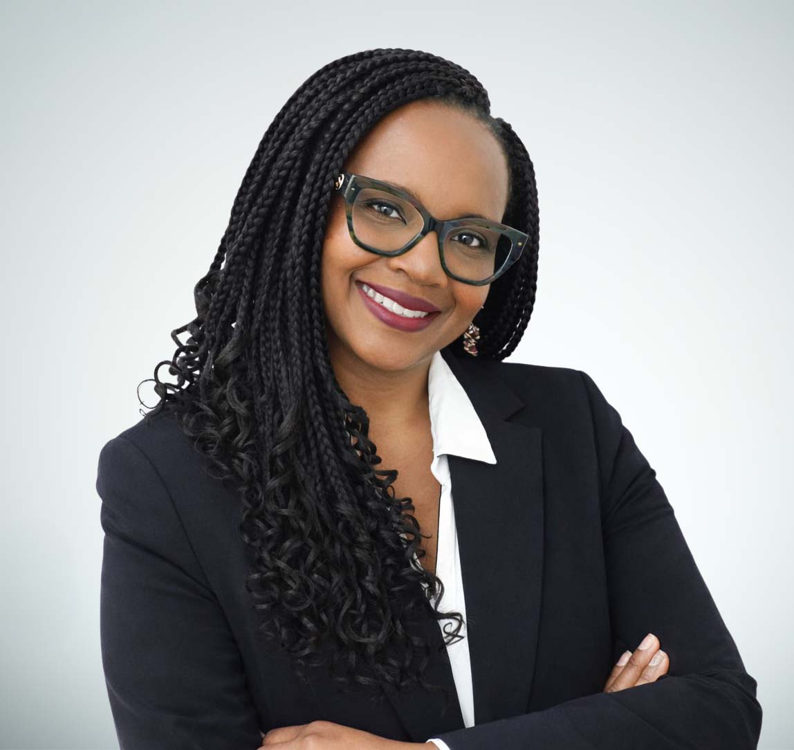 Professional portrait of a confident woman in business attire, smiling with arms crossed