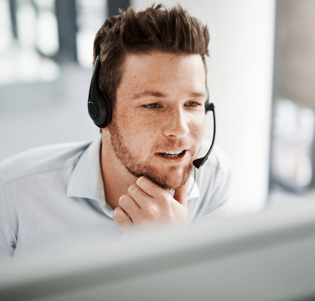 Professional engaged in a video call while using a headset, focused on communication
