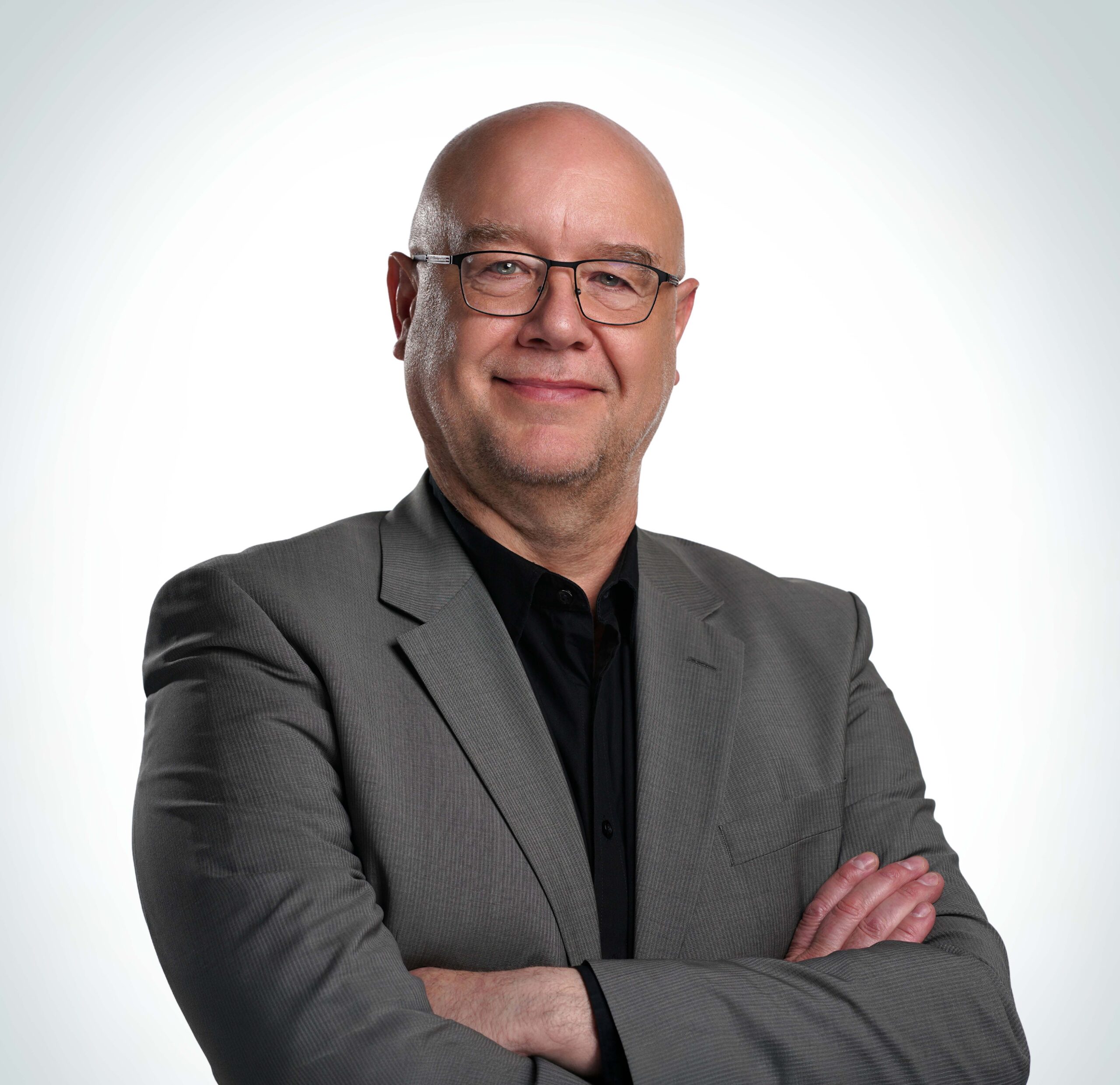 Professional portrait of a confident man in a suit, showcasing a friendly demeanor and approachability