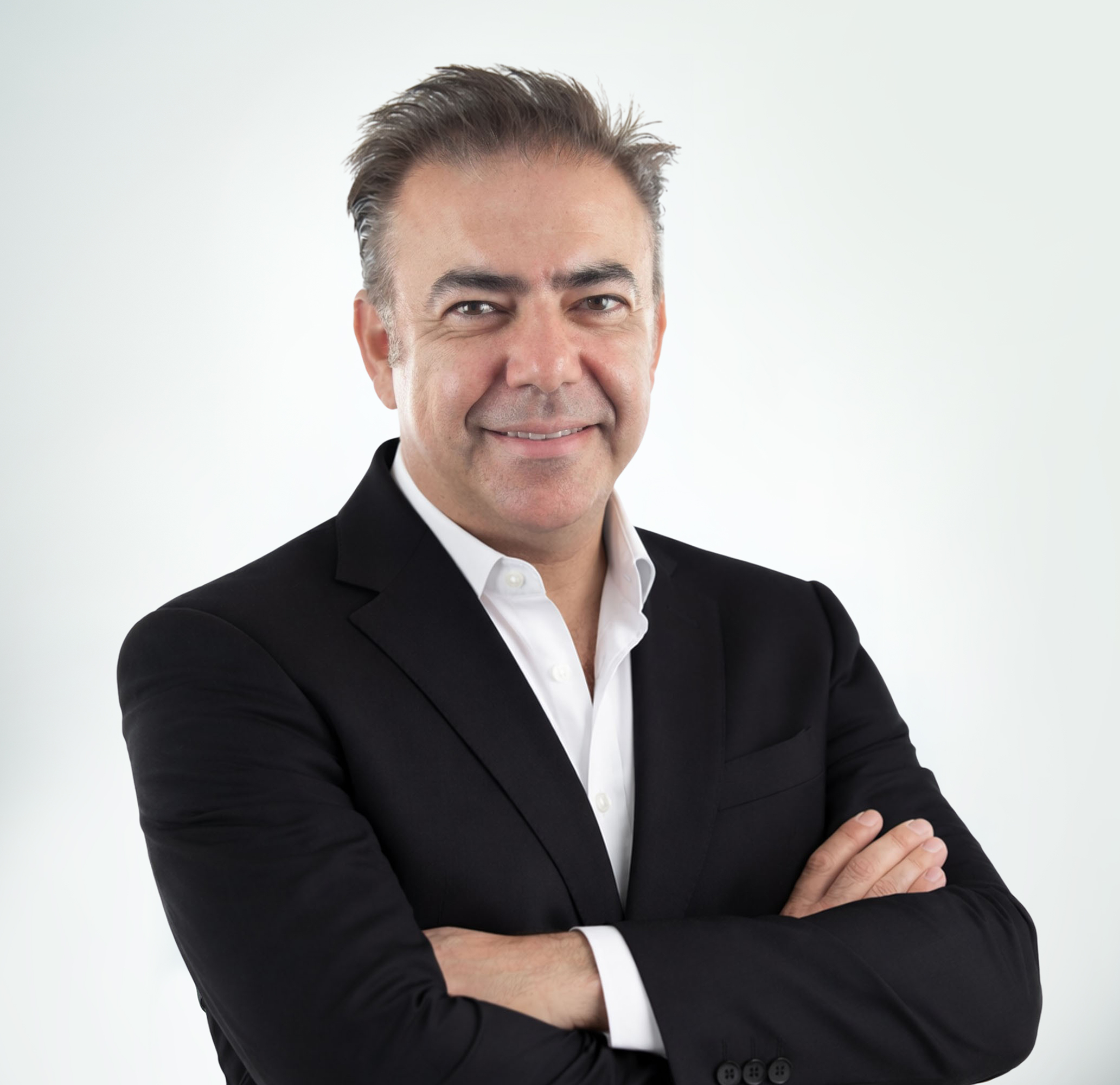 Professional portrait of a smiling man in a suit, showcasing confidence and approachability