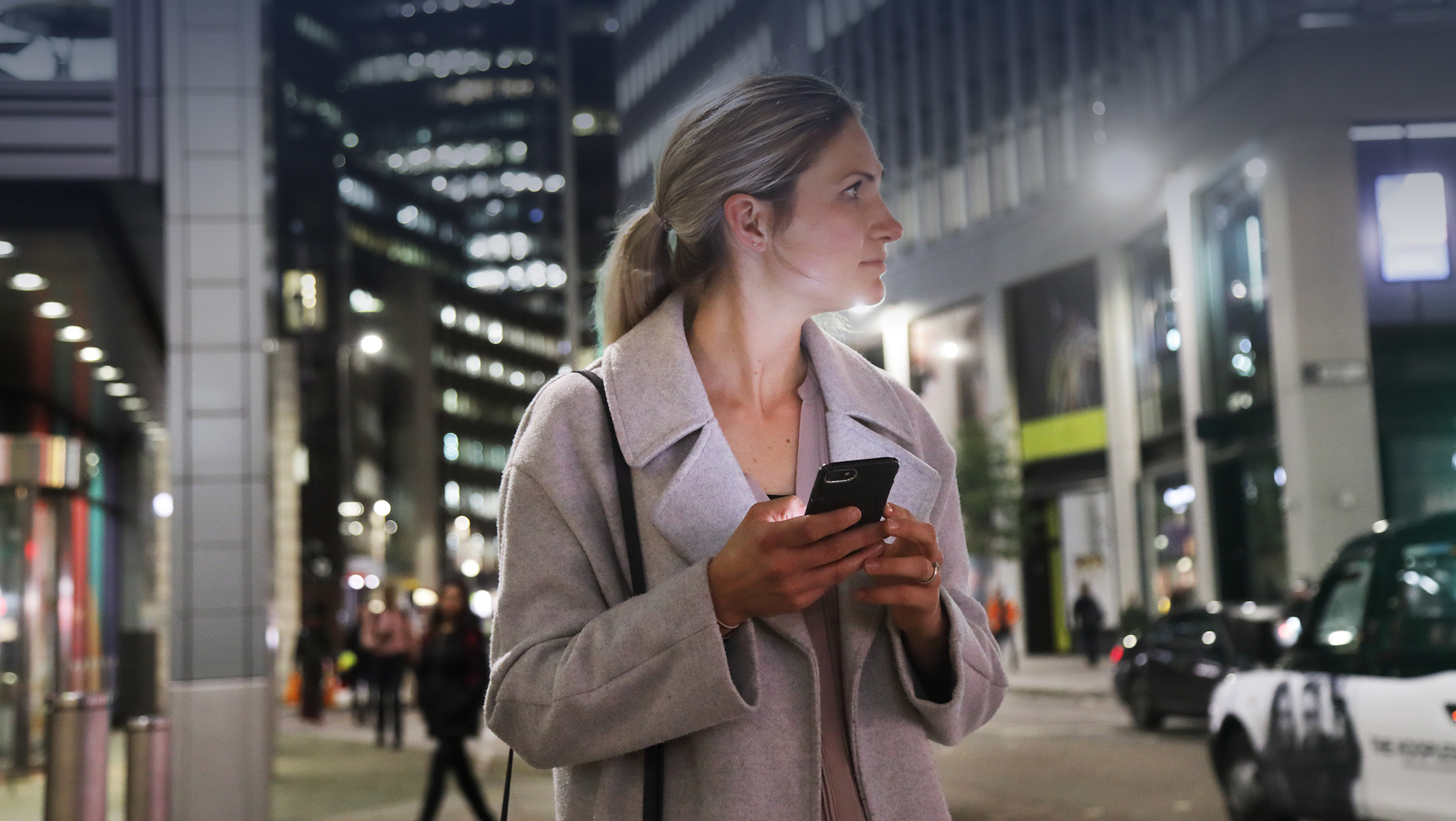 Woman waiting at night with phone